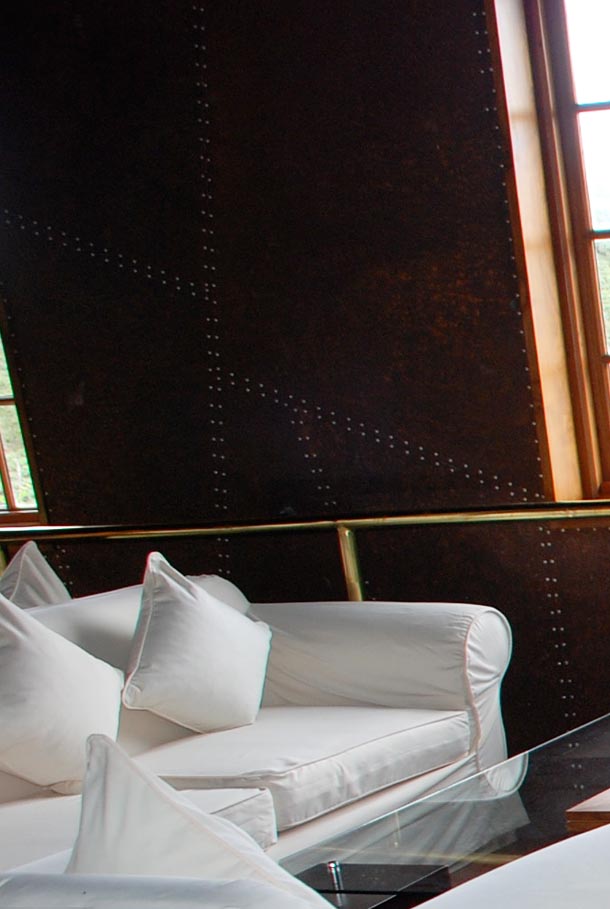 The stark white sofas against the dark factory walls