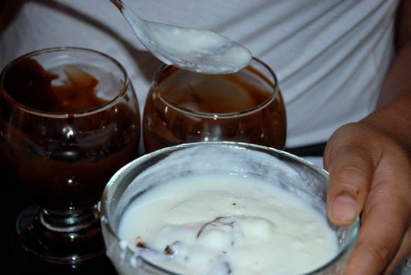 Pouring the yoghurt into the chocolatey sundae bowl Pouring the yoghurt into the chocolatey sundae bowl