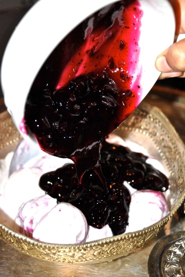 Pouring the Blueberry filling over the Rasgullas Pouring the Blueberry filling over the Rasgullas