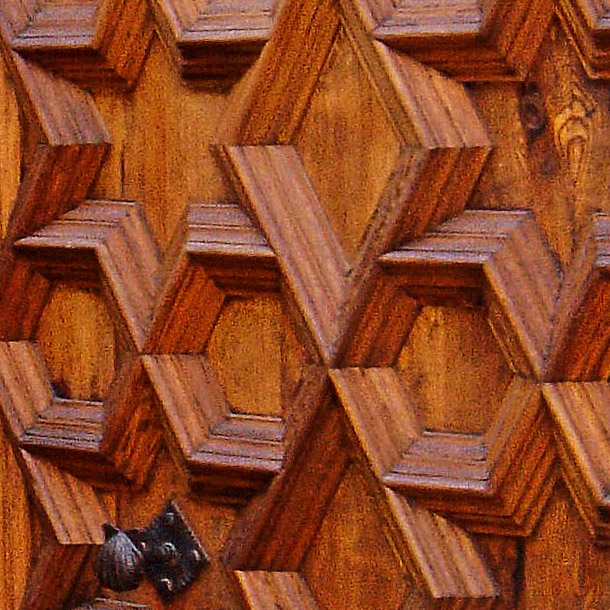 An intricately curved wooden door