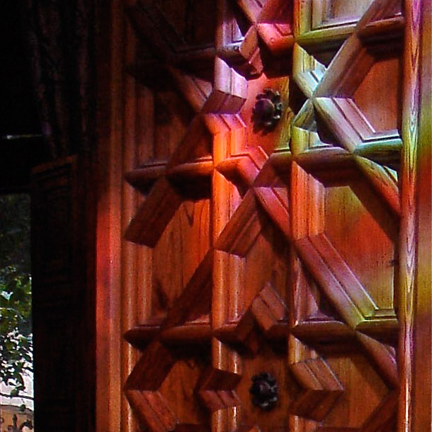 Reflection of stained glass on a wooden door