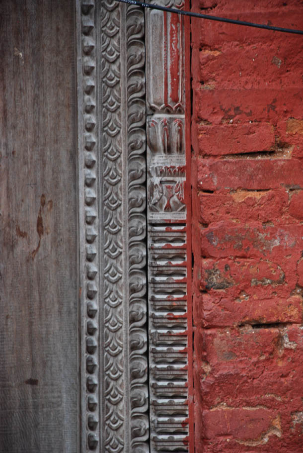 Red bricks, intricate wooden carvings of the Mahasthan Ghar