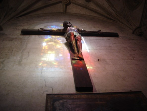 Reflections of a stained glass window on Jesus