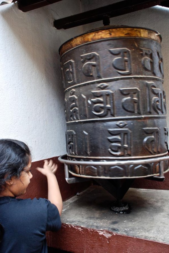 Big Z spinning a huge prayer wheel while chanting the Mantra!