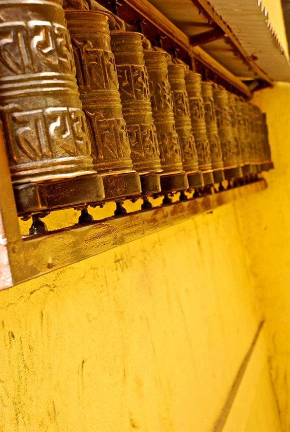 A line of Prayer wheels with the Buddhist Mantra - 'Om Mani Padme Hum' inscribed on it