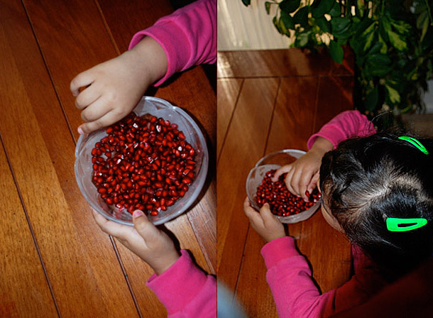 Li'l Z can't take her hands off the pomegranate! Li'l Z can't take her hands off the pomegranate!
