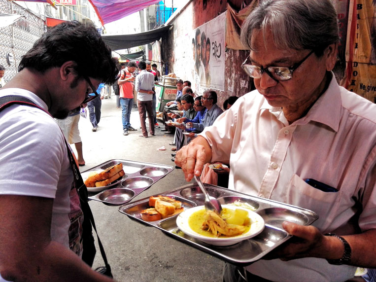 Meshomoshai having his regular lunch of chciken stew and pauruti