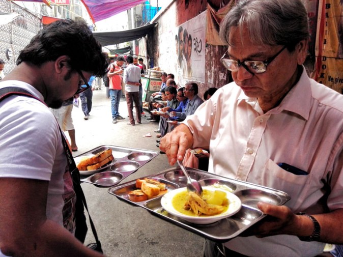 Meshomoshai having his regular lunch of chciken stew and pauruti