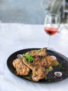 Rabbit fried in garlic, peas, herbs and white wine