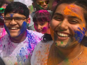 People with Holi colours on their faces