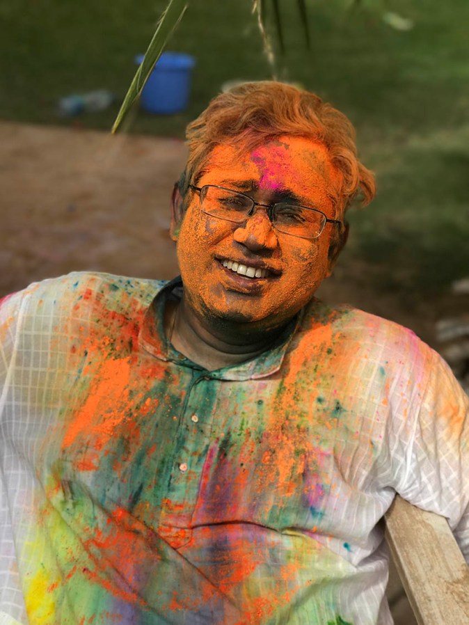 People with Holi colours on their faces