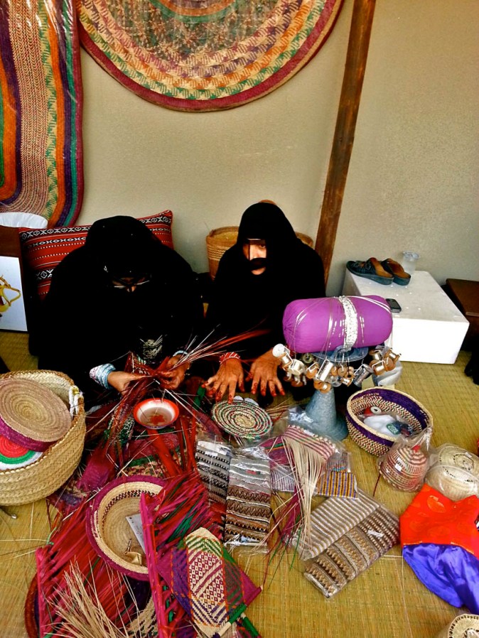 The cylindrical cushion like 'thing' on the stand is called the Talli. And the stand is called Kajoojeh and it's used to make embroidered neck pieces for the Jalabiya, or the traditional dress that an Emirati woman wears