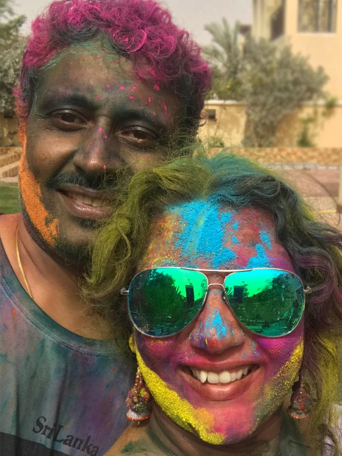 People with Holi colours on their faces