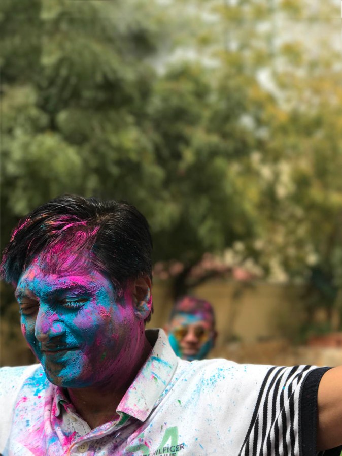 People with Holi colours on their faces