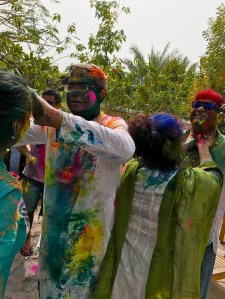 People with Holi colours on their faces