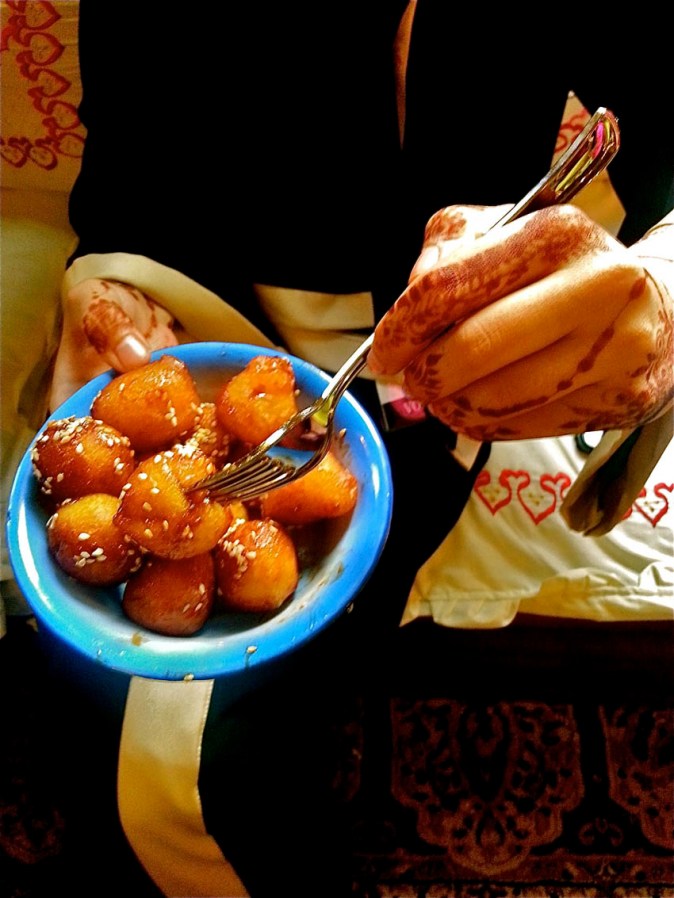 Leqaimat, crispy fried golden dough balls coated with date syrup and sesame seeds. This is one deadly-divine-dessert!